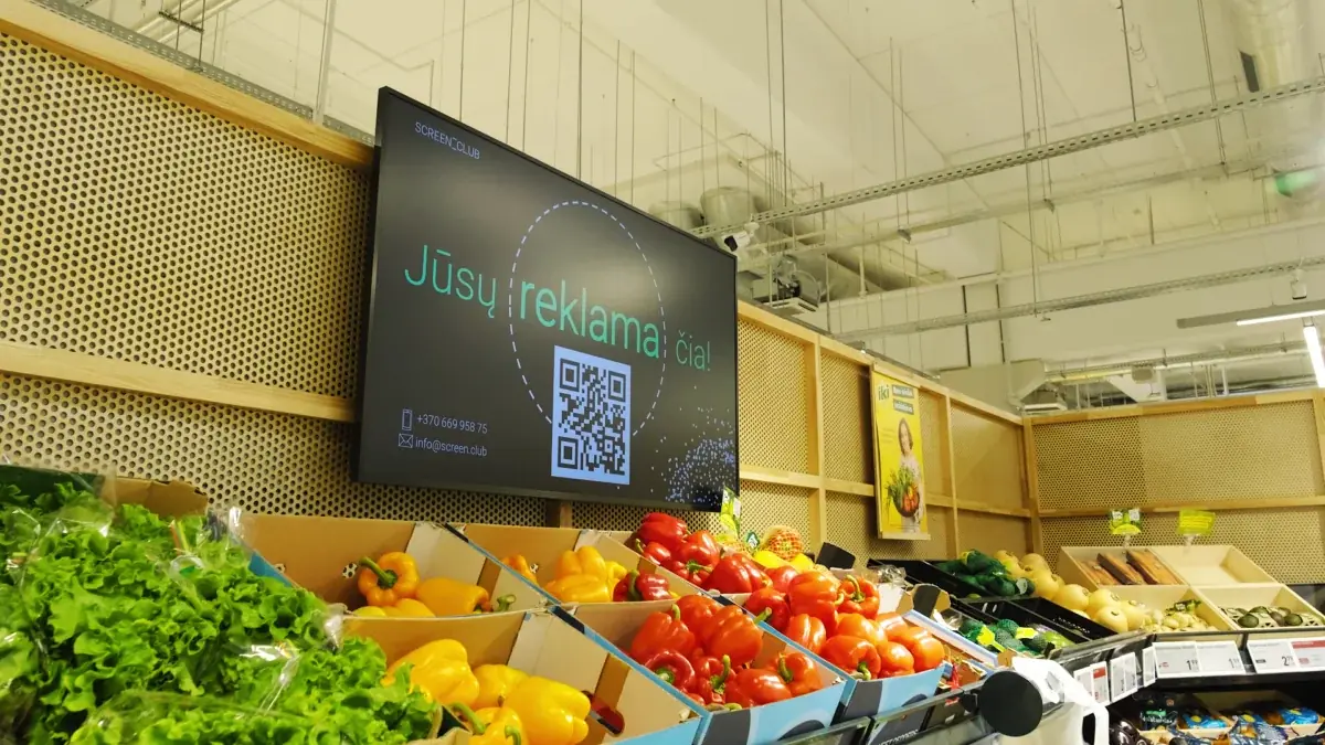 Advertising screens above the produce section of an IKI supermarket